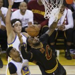Cleveland Cavaliers forward LeBron James (23) reaches for the ball in front of Golden State Warriors guard Leandro Barbosa (19) and forward Anderson Varejao during the first half of Game 7 of basketball's NBA Finals in Oakland, Calif., Sunday, June 19, 2016. (AP Photo/Eric Risberg)