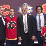 Matthew Tkachuk, second from left, sixth overall pick, stands on stage with members of the Calgary Flames management team and others at the NHL draft in Buffalo, N.Y., Friday June 24, 2016. (Nathan Denette/The Canadian Press via AP) MANDATORY CREDIT