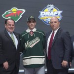 Luke Kunin stands on stage with members of the Minnesota Wild management team at the NHL hockey draft, Friday, June 24, 2016, in Buffalo, N.Y. (Nathan Denette/The Canadian Press via AP)