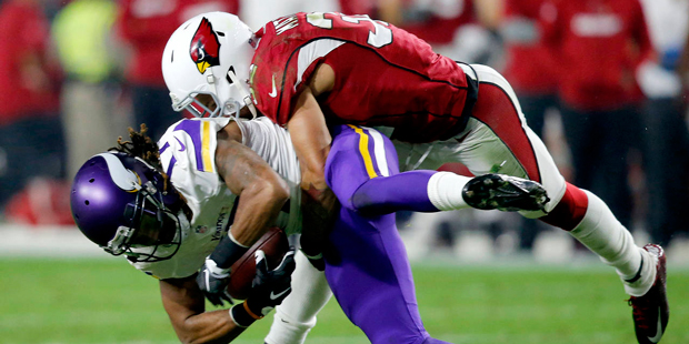 Minnesota Vikings wide receiver Jarius Wright (17) is tackled by Arizona Cardinals free safety Tyra...