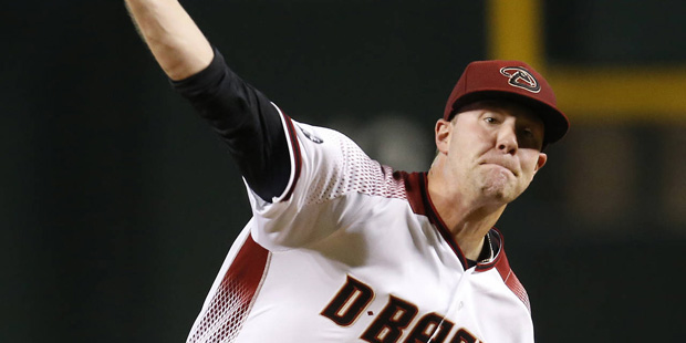 Arizona Diamondbacks Archie Bradley throws in the first inning during a baseball game against the T...