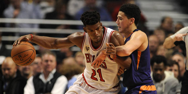 Chicago Bulls' Jimmy Butler (21), drives against Phoenix Suns' Devin Booker (1), during the second ...