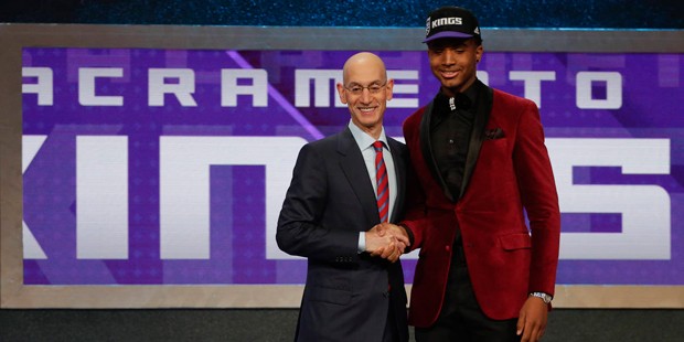 Marquese Chriss, right, poses for a photo with NBA Commissioner Adam Silver after being selected ei...