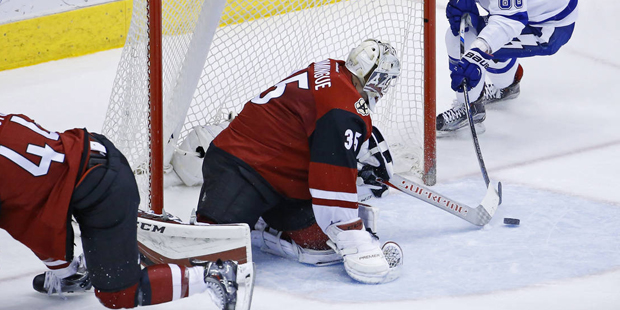 Arizona Coyotes goalie Louis Domingue (35) makes a save against Tampa Bay Lightning right wing Niki...