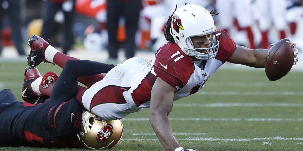 Arizona Cardinals wide receiver Larry Fitzgerald (11) stretches the ball over San Francisco 49ers s...