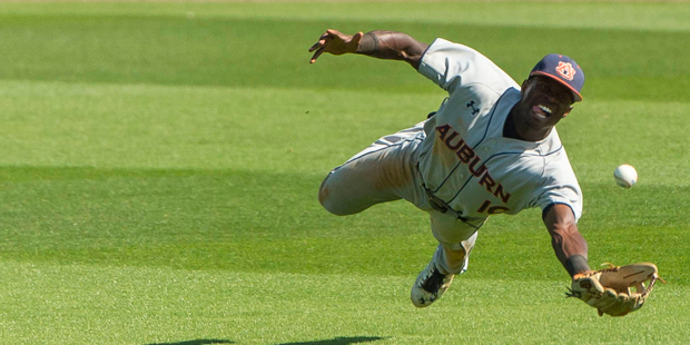 Auburn outfielder Anfernee Grier makes a diving catch in center field during an NCAA college baseba...