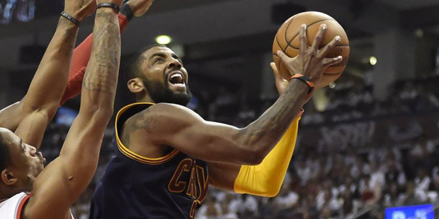 Cleveland Cavaliers guard Kyrie Irving drives to the basket as Toronto Raptors forward DeMarre Carr...