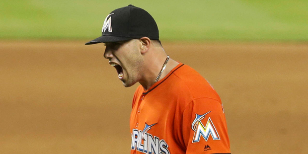 Miami Marlins starting pitcher Jose Fernandez reacts after striking out New York Mets' Wilmer Flore...