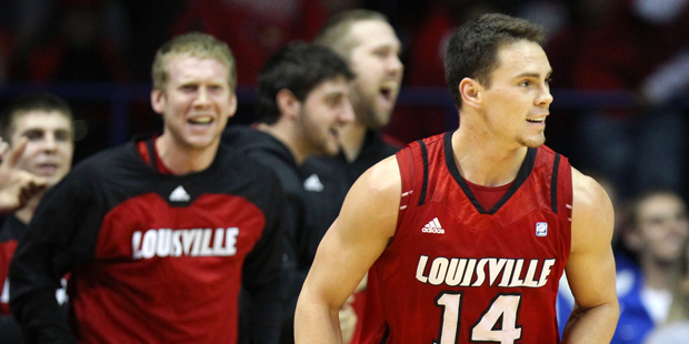 Louisville's Kyle Kuric, right, smiles after scoring against DePaul during the second half of an NC...