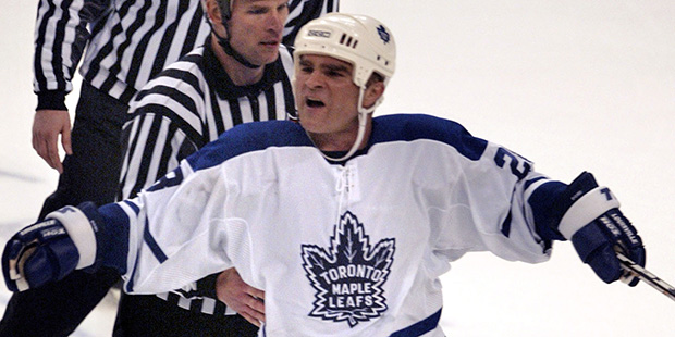 Toronto Maple Leafs' Tie Domi is escorted from the ice following a slaching call on Philadelphia Flyers' Donald Brashear in the third period of their second-round NHL playoffs series game Sunday, May 2, 2004, in Philadelphia.  The Flyers won, 7-2, to take a 3-2 series lead. (AP Photo/Rusty Kennedy)
