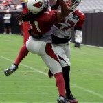 Larry Fitzgerald makes a touchdown catch while Tyvon Branch is in coverage during training camp on July 31. (Photo by Adam Green/Arizona Sports)