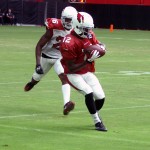 John Brown makes a catch in front of Brandon Williams during training camp on July 31. (Photo by Adam Green/Arizona Sports)