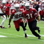 David Johnson turns the corner with the ball as Deone Bucannon pursues during training camp. (Photo by Adam Green/Arizona Sports)