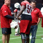 Linebacker Chandler Jones is greeted by GM Steve Keim and president Michael Bidwill prior to training camp practice on July 29. (Photo by Adam Green/Arizona Sports)