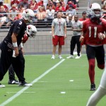 Carson Palmer waits for the snap while Larry Fitzgerald goes in motion during training camp. (Photo by Adam Green/Arizona Sports)