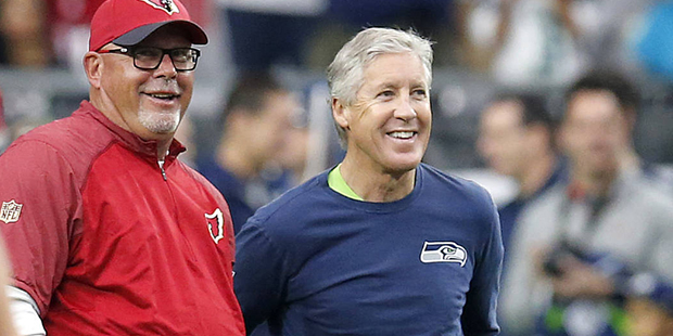 Arizona Cardinals head coach Bruce Arians, left, talks with Seattle Seahawks head coach Pete Carrol...