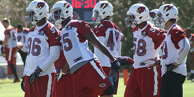Chandler Jones (55) and other members of the defense wait during mini-camp. (Photo by Adam Green/Ar...