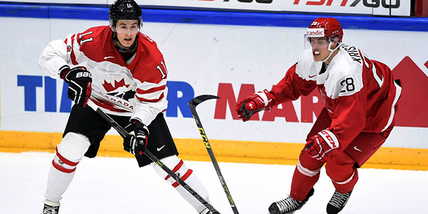 Canada's Brendan Perlini, left, knocks Denmark's Emil Christensen stick out of his hands during thi...