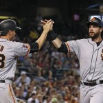 San Francisco Giants' Brandon Belt, right, and Grant Green (38) high-five after they scored runs against the Arizona Diamondbacks during the third inning of a baseball game Sunday, July 3, 2016, in Phoenix. (AP Photo/Ross D. Franklin)
