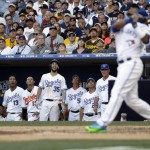 The American League dugout watches American League's Edwin Encarnacion, of the Toronto Blue Jays, hit during the fifth inning of the MLB baseball All-Star Game, Tuesday, July 12, 2016, in San Diego. (AP Photo/Gregory Bull)
