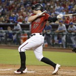 Arizona Diamondbacks' Brandon Drury follows through on his swing for a two-run double against the Los Angeles Dodgers during the first inning of a baseball game Sunday, July 17, 2016, in Phoenix. (AP Photo/Ross D. Franklin)