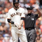 San Francisco Giants' Brandon Belt, left, stands at third base after hitting an RBI-triple against the Arizona Diamondbacks during the third inning of a baseball game Saturday, July 9, 2016, in San Francisco. Umpire Quinn Walcott, right, signals for time. (AP Photo/D. Ross Cameron)