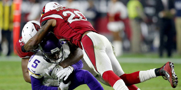 Minnesota Vikings quarterback Teddy Bridgewater (5) is sacked by strong safety Deone Bucannon (20) ...