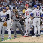 National League's manager Terry Collins (10), of the New York Mets, waits for a new pitcher as Daniel Murphy (20), of the Washington Nationals, Paul Goldschmidt, center, of the Arizona Diamondbacks, Nolan Arenado (28), of the Colorado Rockies, and Corey Seager, left, of the Los Angeles Dodgers, look on during the seventh inning of the MLB baseball All-Star Game, Tuesday, July 12, 2016, in San Diego. (AP Photo/Gregory Bull)