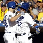 American League's Eric Hosmer, of the Kansas City Royals, left, greets teammate Salvador Perez, of the Kansas City Royals, after hitting a solo home run against the National League during the second inning of the MLB baseball All-Star Game, Tuesday, July 12, 2016, in San Diego. (AP Photo/Gregory Bull)