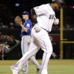 Arizona Diamondbacks left fielder Rickie Weeks Jr. runs to first after being hit by a pitch by Toronto Blue Jays starting pitcher Aaron Sanchez, rear, during the seventh inning of an interleague baseball game, Tuesday, July 19, 2016, in Phoenix. (AP Photo/Matt York)
