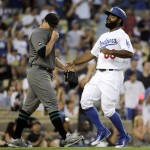 Los Angeles Dodgers' Andrew Toles, right, scores on a double hit by Joc Pederson as Arizona Diamondbacks starting pitcher Zack Godley wipes his face while walking toward the mound during the second inning of a baseball game, Friday, July 29, 2016, in Los Angeles. (AP Photo/Jae C. Hong)