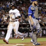 Arizona Diamondbacks' Jean Segura scores on a ground out by Paul Goldschmidt during the first inning of an interleague baseball game as Toronto Blue Jays catcher Russell Martin watches the play, Tuesday, July 19, 2016, in Phoenix. (AP Photo/Matt York)