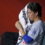 Los Angeles Dodgers' Kenta Maeda, of Japan, wipes sweat from his face as he sits in the dugout after being taken out of the game during the fifth inning of a baseball game against the Arizona Diamondbacks Sunday, July 17, 2016, in Phoenix. (AP Photo/Ross D. Franklin)
