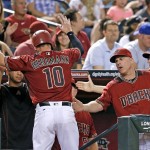 Arizona Diamondbacks' Chris Herrmann (10) celebrates his run scored against the San Diego Padres with Chip Hale (3), Mike Butcher, right, and David Peralta, left, during the third inning of a baseball game Wednesday, July 6, 2016, in Phoenix. (AP Photo/Ross D. Franklin)