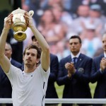 Andy Murray of Britain holds up his trophy after beating Milos Raonic of Canada in the men's singles final on day fourteen of the Wimbledon Tennis Championships in London, Sunday, July 10, 2016. (AP Photo/Ben Curtis)