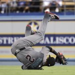 Arizona Diamondbacks second baseman Jean Segura takes a tumble after catching a ball hit by Los Angeles Dodgers' Adrian Gonzalez during the sixth inning of a baseball game, Friday, July 29, 2016, in Los Angeles. (AP Photo/Jae C. Hong)