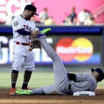 National League's Carlos Gonzalez, of the Colorado Rockies, is caught stealing by American League's Jose Altuve, of the Houston Astros, left, during the fourth inning of the MLB baseball All-Star Game, Tuesday, July 12, 2016, in San Diego. (AP Photo/Gregory Bull)