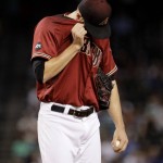 Arizona Diamondbacks starting pitcher Patrick Corbin (46) wipes his face after giving up a two run home run against the Toronto Blue Jays during the first inning of an interleague baseball game, Wednesday, July 20, 2016, in Phoenix.  (AP Photo/Matt York)