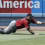 Arizona Diamondbacks left fielder Yasmany Tomas dives but cannot catch an RBI double by Los Angeles Dodgers' Yasiel Puig during the fifth inning of a baseball game in Los Angeles, Sunday, July 31, 2016. The Dodgers won 14-3. (AP Photo/Alex Gallardo)