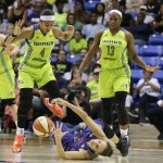 Phoenix Mercury guard Diana Taurasi, bottom, falls in front of Dallas Wings guards Skylar Diggins (4) and Karima Christmas (13) during the second half of a WNBA basketball game in Arlington, Texas, Tuesday, July 5, 2016. The Wings won 77-74. (AP Photo/LM Otero)