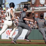 Arizona Diamondbacks starting pitcher Archie Bradley (25) outruns San Francisco Giants' Conor Gillespie (21) to first base to make an unassisted putout during the first inning of a baseball game on Sunday, July 10, 2016, in San Francisco. Arizona second baseman Jean Segura also moves on the bag. (AP Photo/D. Ross Cameron)