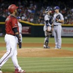 Arizona Diamondbacks' Jean Segura, left, walks slowly down to first base as he looks at San Diego Padres pitcher Colin Rea, right, as Rea meets with catcher Derek Norris after Segura was hit by a pitch during the second inning of a baseball game Wednesday, July 6, 2016, in Phoenix. (AP Photo/Ross D. Franklin)