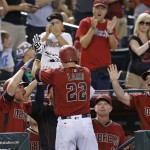 Arizona Diamondbacks' Jake Lamb (22) celebrates his two-run home run against the San Francisco Giants with manager Chip Hale, right, bench coach Glenn Sherlock, second from right, and Brandon Drury, left, during the eighth inning of a baseball game Sunday, July 3, 2016, in Phoenix. (AP Photo/Ross D. Franklin)