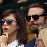 Actor Bradley Cooper, right, and Sophie Hunter, wife of Benedict Cumberbatch, watch as Andy Murray of Britain plays Milos Raonic of Canada in the men's singles final on the fourteenth day of the Wimbledon Tennis Championships in London, Sunday, July 10, 2016. (Andy Couldridge/Pool Photo via AP)