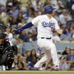 Los Angeles Dodgers' Joc Pederson, right, watches his two-run double during the second inning of a baseball game against the Arizona Diamondbacks, Friday, July 29, 2016, in Los Angeles. (AP Photo/Jae C. Hong)