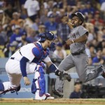 Arizona Diamondbacks' Michael Bourn, right, scores on a double by Paul Goldschmidt as Los Angeles Dodgers catcher Yasmani Grandal waits for the throw during the seventh inning of a baseball game, Friday, July 29, 2016, in Los Angeles. (AP Photo/Jae C. Hong)