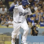 Los Angeles Dodgers' Yasmani Grandal pumps his fist after hitting an RBI single during the seventh inning of a baseball game against the Arizona Diamondbacks, Friday, July 29, 2016, in Los Angeles. (AP Photo/Jae C. Hong)