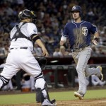 San Diego Padres' Wil Myers scores on aan RBI double by teammate Matt Kemp during the fifth inning of a baseball game as Arizona Diamondbacks catcher Welington Castillo, left, waits for the throw, Tuesday, July 5, 2016, in Phoenix. (AP Photo/Matt York)
