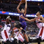 Phoenix Suns guard Devin Booker, center, goes to the basket against Washington Wizards center DeJuan Blair, left, Gary Neal, second from left, and Otto Porter Jr. (22) during the first half of an NBA basketball game, Friday, Dec. 4, 2015, in Washington. (AP Photo/Nick Wass)
