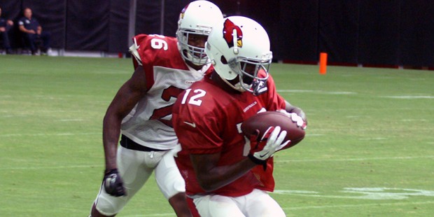 John Brown makes a catch in front of Brandon Williams during training camp on July 31. (Photo by Ad...